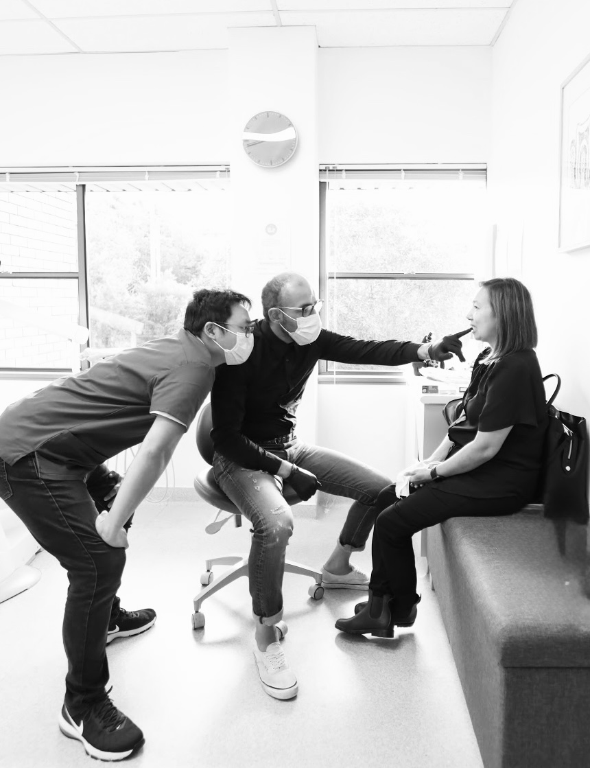 Mo with a patient and clinician in the studio, discussing the smile design