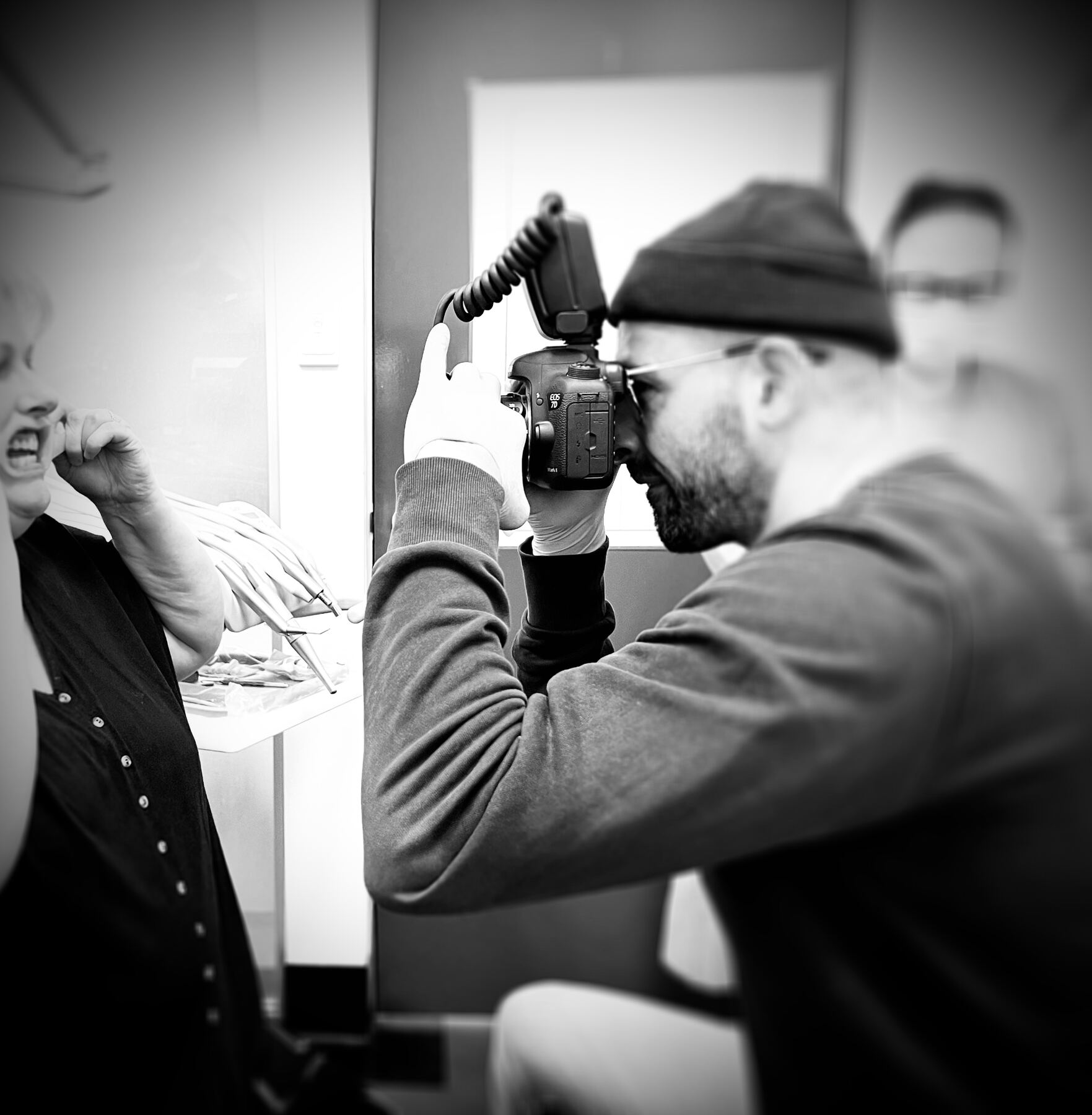 Mo photographing a patient's teeth through loupes